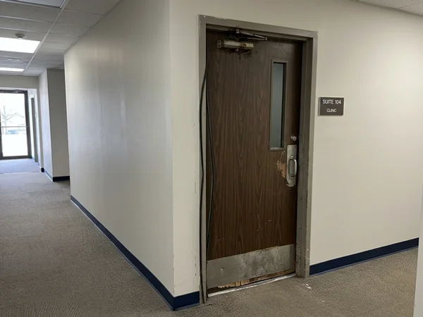 Before: heavy manual clinic suite door in Markham