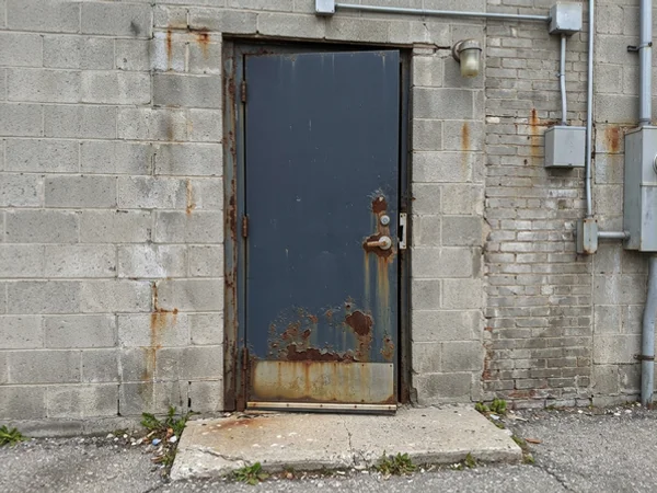 Before: rusted exit door that no longer latches in Etobicoke