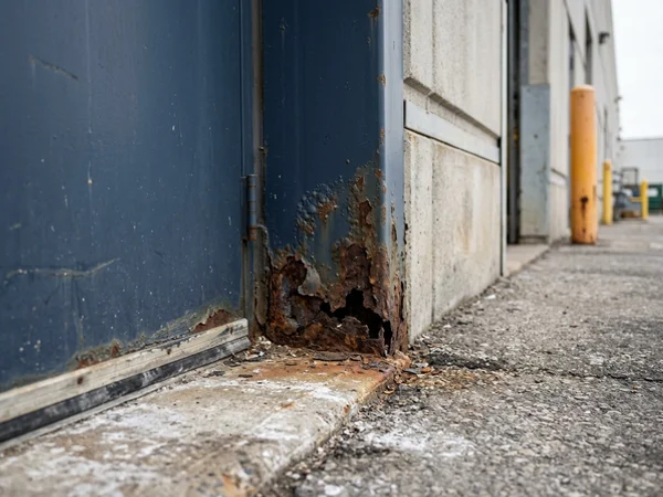 Before: frame rusted through at grade in Brampton