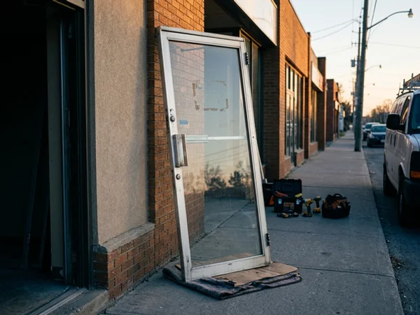 Old narrow stile storefront door removed at sunrise
