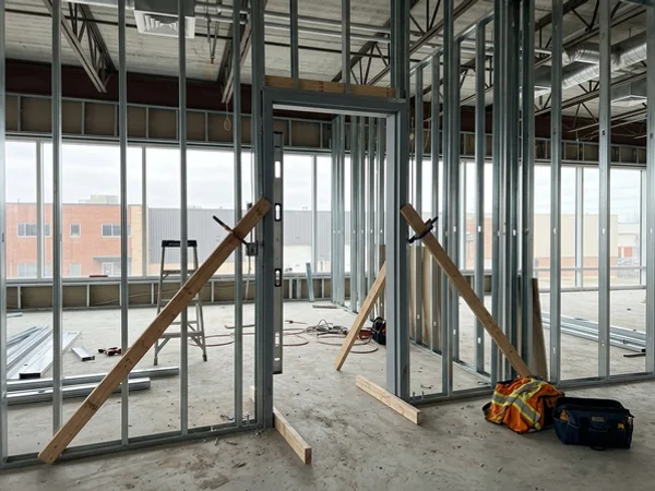 Welded hollow metal frame braced in a steel stud partition before drywall